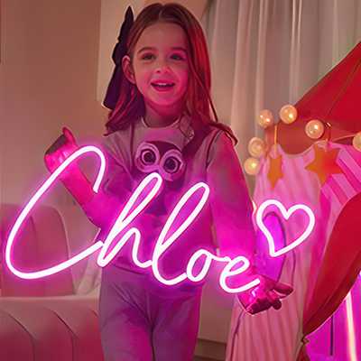 Name sign for Chloe with a love heart in pink LED neon held by Chloe in her bedroom