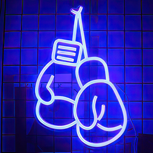 Boxing gloves in blue LED and mounted on a wall in gym