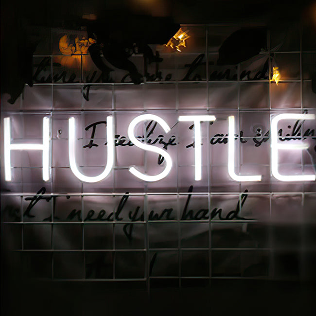Hustle neon sign in white LED lights for an office or workplace