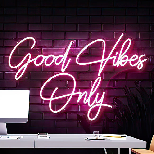 Good vibes only neon sign in an office space setting