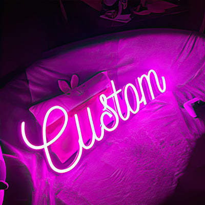 Custom LED sign on a bed with purple glow