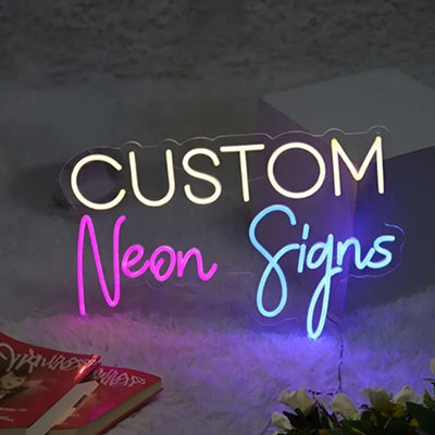 Custom neon signs in white, pink and blue LED lights