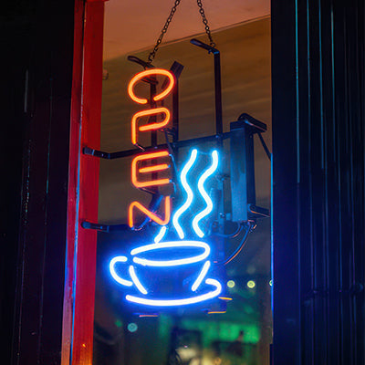 open sign with steaming coffee cup outside a coffee shop