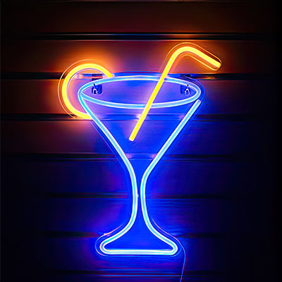 Neon cocktail glass with straw and lemon in LED light