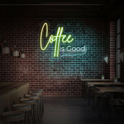 Coffee Is Good neon sign on a cafe wall in yellow and white LED lights
