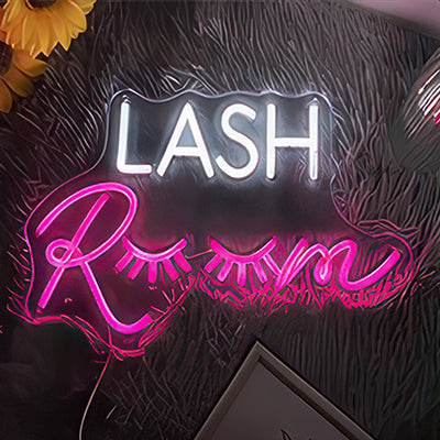 Lash room neon sign with the oo looking like eyelids with long lashes in white and pink neon