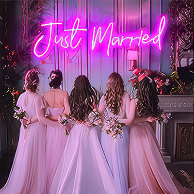 Just married neon sign in pink LED lights with 4 bridesmaids and bride in front